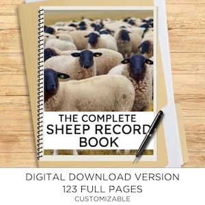 May include: A spiral-bound record book featuring a photograph of a flock of sheep with black faces and white wool. The cover displays the text THE COMPLETE SHEEP RECORD BOOK in black capital letters. A black ballpoint pen rests on the cover.