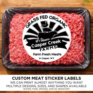 May include: A package of raw ground beef labeled "Grass Fed Organic" from Casper Creek Farms. The label features a black and white farm scene. The package is in a black tray, wrapped in clear plastic. The text at the bottom says "Custom Meat Sticker Labels".