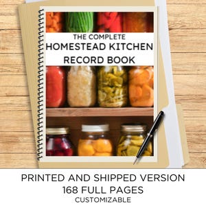 May include: A spiral-bound record book titled The Complete Homestead Kitchen Record Book, featuring a cover image of glass jars filled with preserved food on wooden shelves. A black and silver pen rests on the cover of the 168-page printed book.