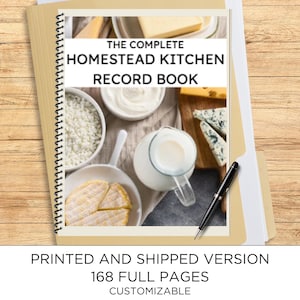 May include: A spiral-bound record book titled THE COMPLETE HOMESTEAD KITCHEN RECORD BOOK, featuring a cover image of various dairy products including milk, cheese, and butter. A black pen rests on the cover, which notes 168 full pages.