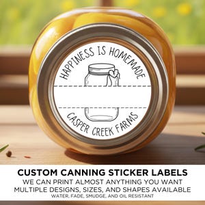May include: A canning jar with a white label that reads "Happiness is Homemade" and "Casper Creek Farms". The label features a jar illustration and a heart. The jar is filled with yellow fruit. The image also shows text that says "Custom Canning Sticker Labels".