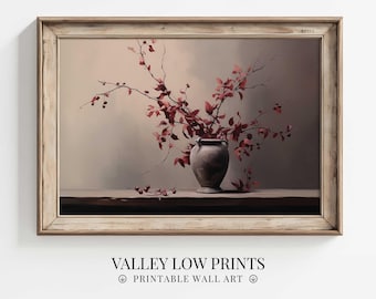 May include: A framed print of a still life featuring a gray vase filled with branches of red leaves and berries. The artwork is set against a neutral background and is labeled "VALLEY LOW PRINTS PRINTABLE WALL ART". The frame is a light brown color.