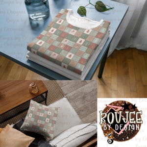 May include: A stack of folded white t-shirts with a patterned top layer. The top shirt features a patchwork design in shades of green, pink, and beige. The design includes squares with various holiday-themed motifs. The shirts are on a light blue table.