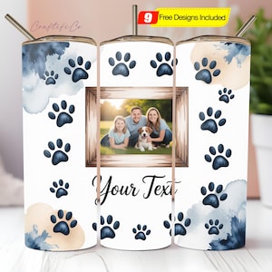 May include: A white tumbler with a photo frame, paw prints, and watercolor accents. The frame holds a family portrait with a dog. The text "Your Text" is below the frame. Includes a straw and the text "9 Free Designs Included".
