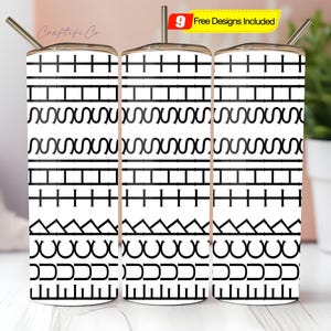 May include: Three white tumblers with black geometric patterns and silver straws. The designs include horizontal lines, zigzags, and curved shapes. A small yellow sign reads "9 Free Designs Included".