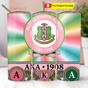 May include: A set of three insulated tumblers with a colorful design. The tumblers feature the Alpha Kappa Alpha sorority crest, the text "AKA 1908", and the Greek letters "A" and "K". Each tumbler has a straw.