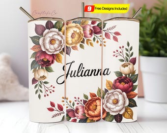May include: A white tumbler with a floral design featuring burgundy, cream, and gold flowers. The name "Julianna" is written in a cursive font. A metal straw is inserted in the lid. The text "9 Free Designs Included" is visible.