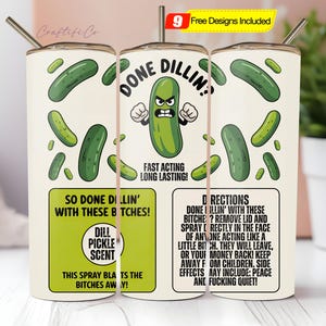 May include: A white tumbler with a stainless steel straw, featuring a cartoon pickle with an angry face and the words "DONE DILLIN!". The design includes green pickles and text that reads "So Done Dillin' With These B*tches!" and "Dill Pickle Scent".