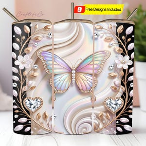 May include: A cylindrical tumbler featuring a pastel iridescent butterfly at the center, surrounded by gold vines, white flowers, and diamond-like heart accents against a swirling cream and black background. Includes a straw and text 9 Free Designs Included.