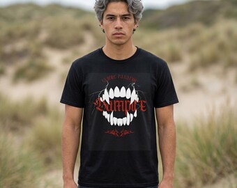 May include: A black short-sleeved t-shirt featuring a graphic print of white vampire fangs with lightning-like accents. The text "EX MALE PARADISE" appears above the fangs, and the word "VAMPIRE" is printed in a bold red gothic font across the center.