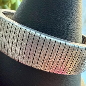 May include: A set of three ceramic mugs with a speckled, matte finish. The mugs are in shades of cream, light gray, and dark gray. Each mug has a simple, minimalist design, perfect for coffee or tea.