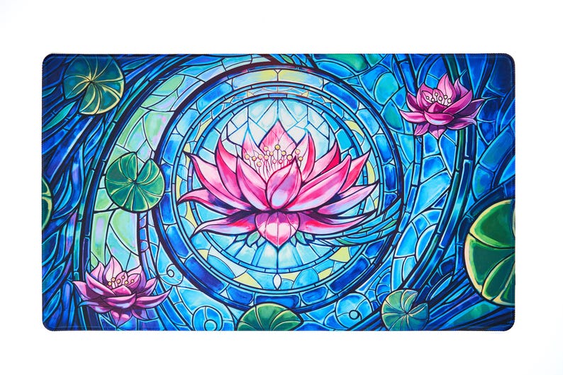 May include: A blue and green stained glass design with pink lotus flowers. The design features a circular pattern with a central lotus flower and two smaller lotus flowers on either side.