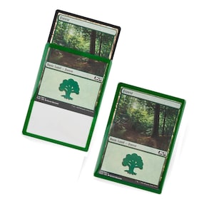 May include: Two green Magic: The Gathering Forest cards with a green tree symbol in the bottom right corner. The cards are from the M20 set.