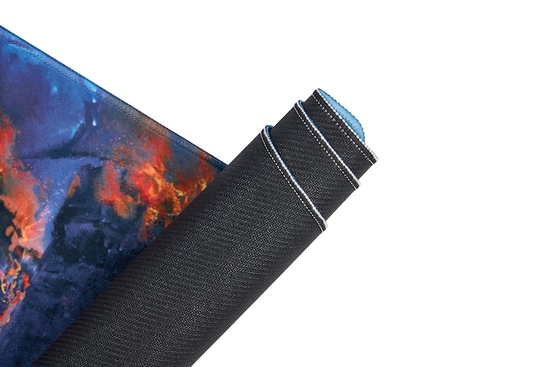 May include: A rolled up gaming mouse pad with a colorful galaxy design on the top and a black rubberized bottom.