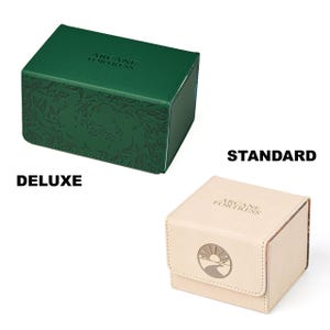 May include: Two card game storage boxes, one green with a leafy pattern and the text "Arcane Fortress" and the other beige with a sun and wave design and the text "Arcane Fortress". The boxes are labeled "Deluxe" and "Standard".