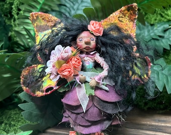 Dark Skinned Flower Fairy in an Artificial Purple Rose Dress and Salmon Pink Iridescent Wings