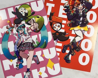 May include: Two colorful art prints featuring anime-style characters. One print is pink with the text "MIKU" and a character with teal hair. The other is red with the text "TEO" and a character with red hair. Both prints have a white background.