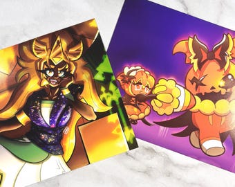 May include: Two art prints featuring colorful anime-style illustrations. One print showcases a character with golden hair and a cosmic-themed top. The other print displays two pumpkin-themed characters against a purple background.