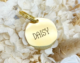 May include: Gold-colored metal pet tag with the name "Daisy" engraved on it.
