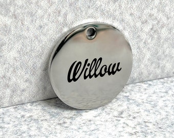 May include: A silver round pet tag with the name "Willow" engraved in black lettering.