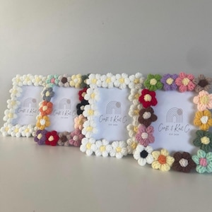 May include: Four rectangular picture frames decorated with crocheted flowers in various colours including white, yellow, red, pink, green, and brown. Each frame contains a white insert featuring a rainbow logo and the text Craft & Knit Co.