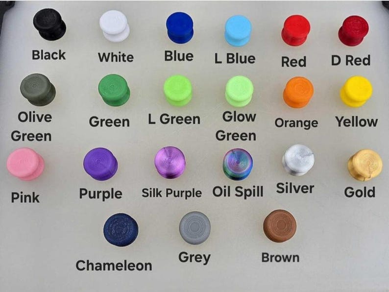 Puede incluir: Una colecci&oacute;n de tapones coloridos en varios tonos, incluyendo negro, blanco, azul, rojo y verde. Cada tap&oacute;n est&aacute; etiquetado con su nombre de color correspondiente, como "Rosa", "Morado" y "Dorado".