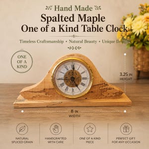 May include: A spalted maple table clock with a gold-rimmed face, Roman numerals, and an ornate center. The wood features natural dark grain patterns. The clock measures 8 inches in width and 3.25 inches in height, as indicated by the text.