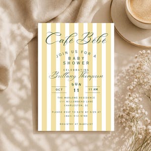 May include: A rectangular baby shower invitation card featuring vertical yellow and white stripes. The text reads: Café Bébé, Join us for a baby shower celebrating Brittany Thompson, Sun Oct 11, 11 AM, The Marlowe Residence, 111 Willowbend Lane, Charleston, SC.