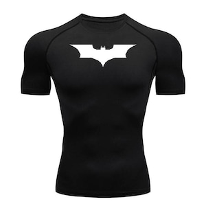 May include: Black short-sleeved shirt with a white Batman logo on the front.