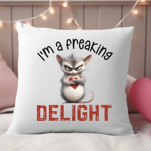 May include: White throw pillow with a cartoon mouse holding a red heart and the text "I'm a freaking DELIGHT" in black and red.