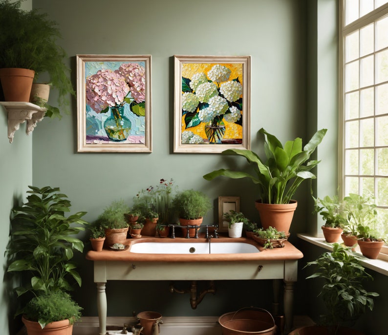 May include: A bathroom with a green wall, a white porcelain sink, and a wooden countertop. There are two framed paintings of hydrangeas on the wall, and several potted plants throughout the room.