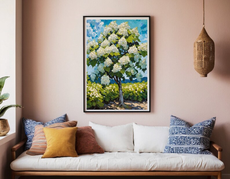 May include: A framed painting of a white flowering tree with green leaves against a blue sky with white clouds. The tree is in a field of green bushes.