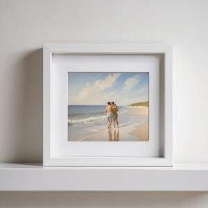 May include: A framed photograph of two people embracing on a beach. The photo is in a white frame and the people are wearing swimsuits.