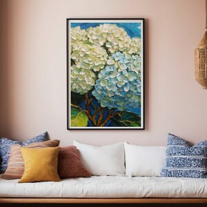 May include: A framed painting of a cluster of white and blue hydrangeas with a blurred background of blue sky and green leaves.