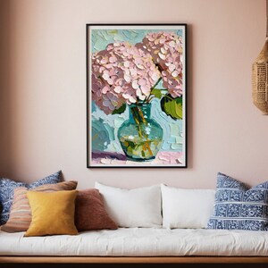 May include: A painting of a bouquet of pink hydrangeas in a blue glass vase. The flowers are arranged in a loose, natural style, and the vase is sitting on a table with a light blue background.