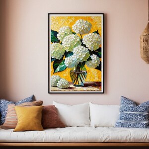 May include: A painting of a bouquet of white hydrangeas in a clear glass vase with a yellow background. The vase is sitting on a table with a green tablecloth.