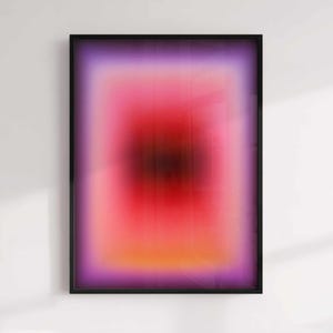 May include: Abstract art print in a black frame, showcasing a vibrant colour gradient. The artwork transitions from a purple border to pink, red, and orange hues at the centre. A modern piece for any interior.