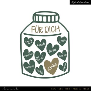 Könnte beinhalten: Ein grünes Glas mit dem Schriftzug "FÜR DICH" auf dem Deckel. Im Glas befinden sich Herzen mit deutschen Wörtern wie "Mut", "Freude", "Stärke", "Glück", "Liebe", "Sonne", "Frieden", "Hoffnung", "Inspiration", "Lächeln" und "Vertrauen".