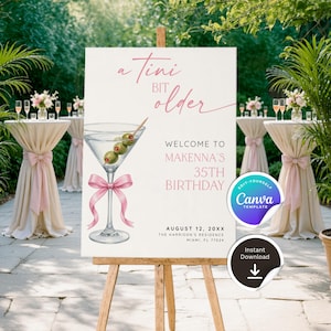 May include: A white sign on a wooden easel with the text "a tini bit older" and "Welcome to Makenna's 35th Birthday". A martini glass with olives and a pink bow is illustrated. The sign also includes the date and location.