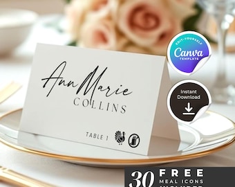 May include: A white place card with the name "Ann Marie Collins" in black script. The card includes table number and meal icons. A Canva template and instant download are available. The card is on a white plate with a gold rim.