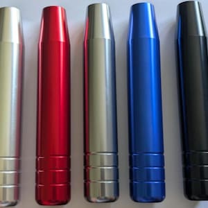 Peut inclure: Cinq cylindres métalliques de couleurs argent, rouge, argent, bleu et noir. Chacun a un sommet conique et une base rainurée. Les objets sont disposés verticalement, possiblement des composants.