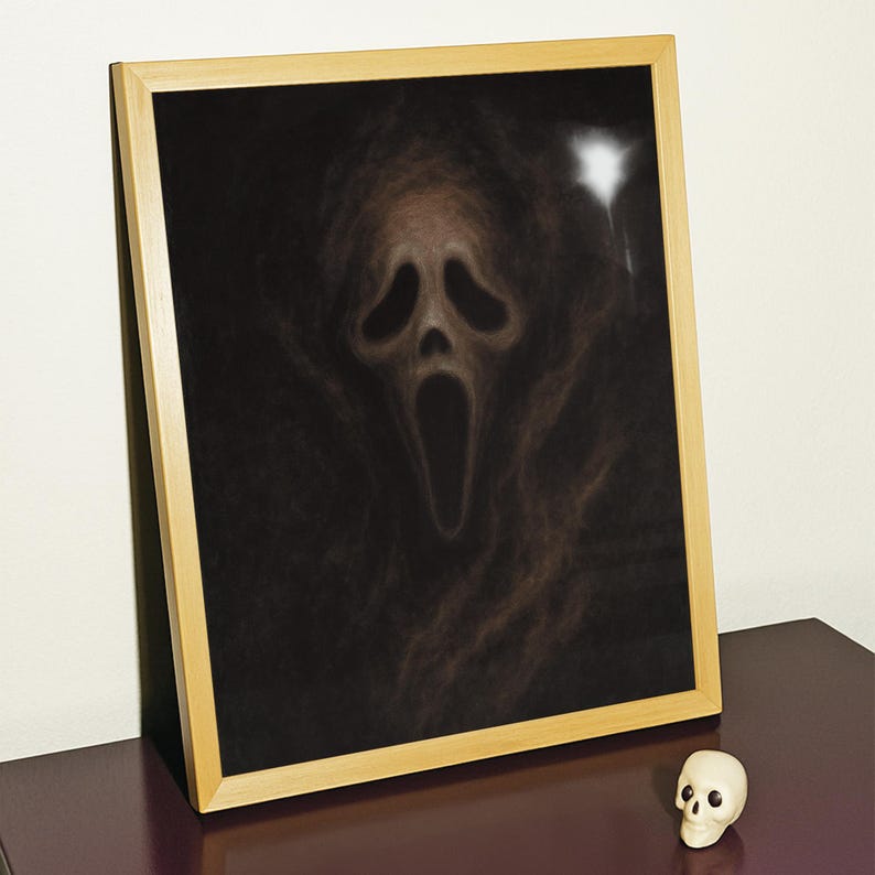 May include: A framed print featuring the iconic Scream mask against a dark background. The artwork is in a wooden frame, and a small white skull figurine sits nearby. The image evokes a sense of horror and suspense.