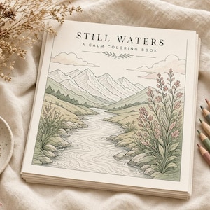 May include: A square coloring book titled Still Waters A Calm Coloring Book featuring a line art illustration of a river flowing through a mountain landscape with wildflowers in the foreground, printed on white paper with black ink.