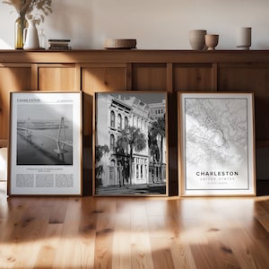 May include: Three black and white framed prints of Charleston, South Carolina. The left print shows the Cooper River Bridge. The middle print shows a street scene with buildings and palm trees. The right print shows a map of Charleston.