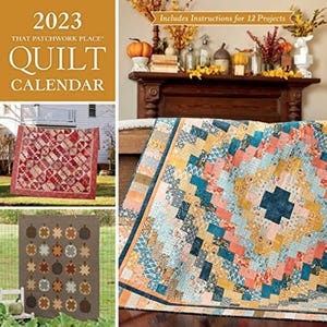 May include: 2023 That Patchwork Place Quilt Calendar featuring 12 quilt projects with instructions. The cover shows a quilt with a patchwork design in shades of blue, yellow, orange, and brown.