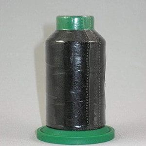 May include: A spool of black thread with a green plastic top and base. The thread is wrapped around a clear plastic bobbin.