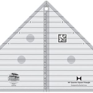 May include: A clear plastic 90° Quarter-Square Triangle ruler with markings up to 8 inches. The ruler has three circles for marking fabric and a QR code. The text "90° Quarter-Square Triangle" and "Designed by Rachael Crow" is printed on the ruler.