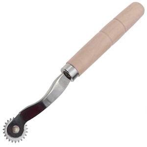 May include: A silver sewing tool with a wooden handle. The tool has a wheel with sharp points and a curved metal shaft.