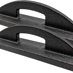 May include: Two black cast iron handles with a textured surface. Each handle has a rectangular base and an arched top with a rectangular opening for gripping. The handles are designed for lifting or carrying.
