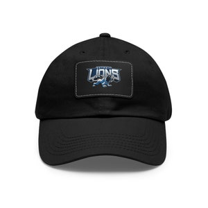 May include: A black baseball cap with a patch featuring a blue and silver Detroit Lions logo. The logo features a lion with the words "Detroit Lions" above it.